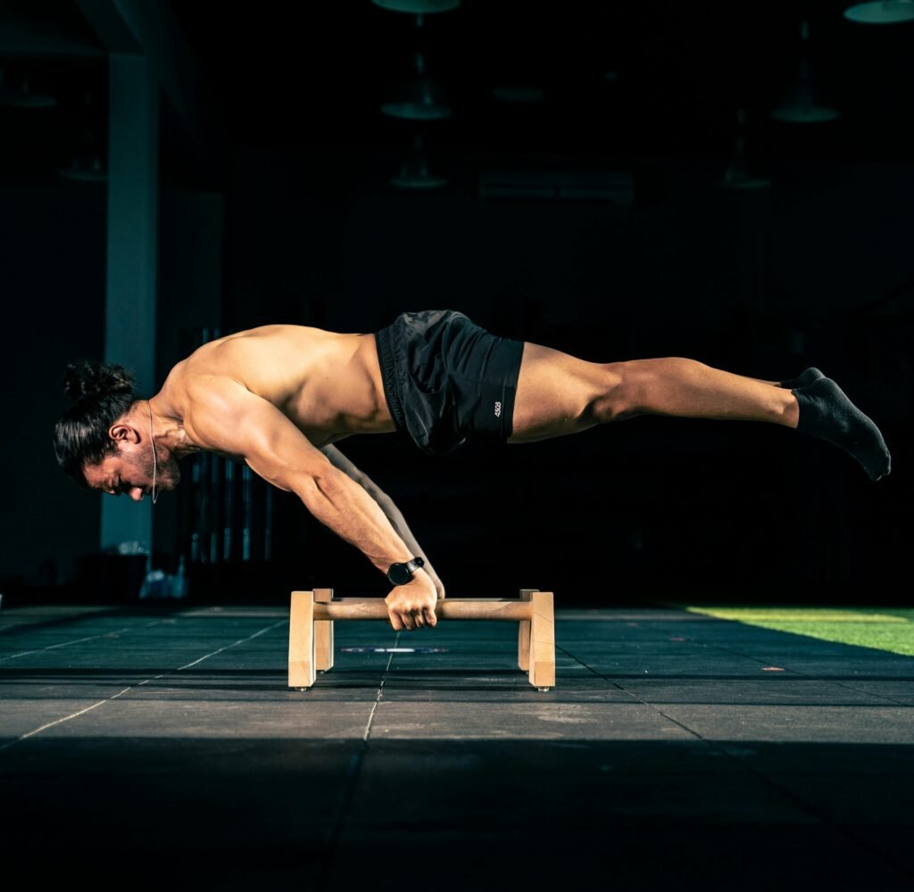 Male athlete demonstrating strength with gymnastic training indoors.